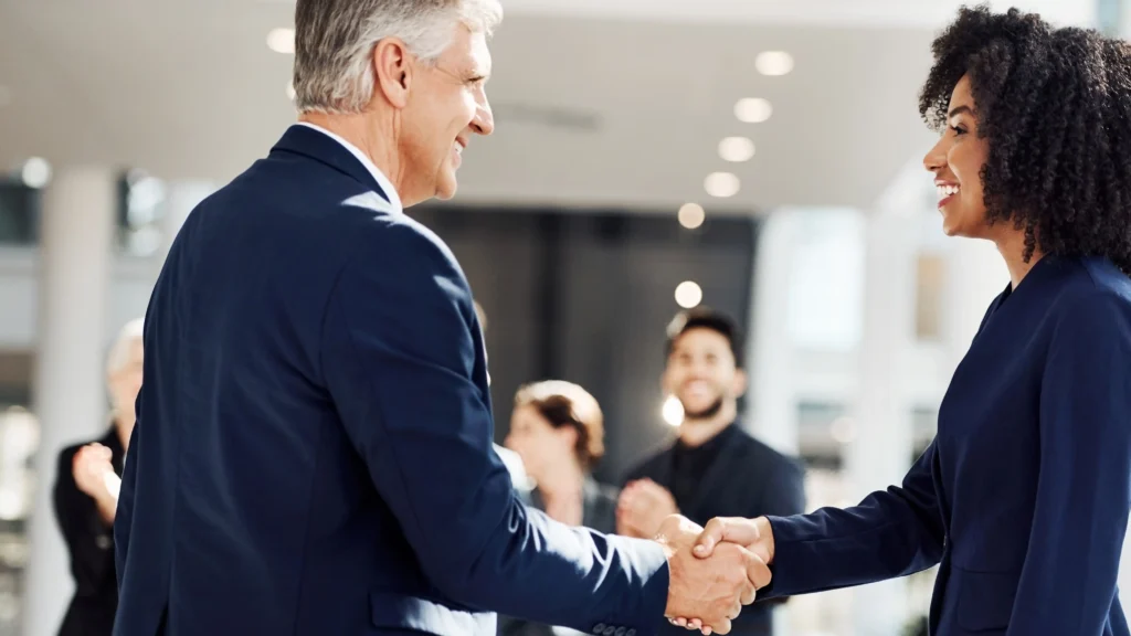 photo of two business people shaking hands representing Altair advisers choosing GlobalMeet as their virtual events platform