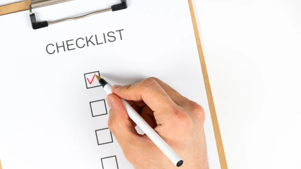 a photo of a hand checking of a checklist representing checking off the items on a virtual event checklist