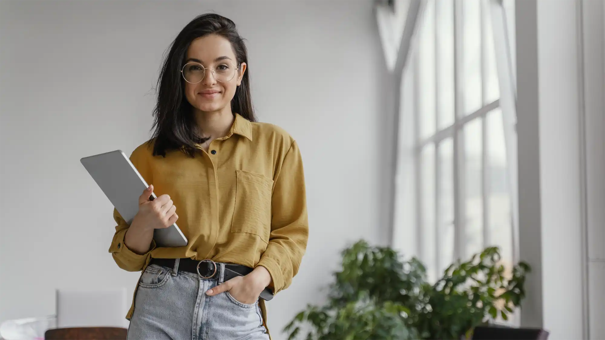 photo of a young virtual events consultant standing with a pad of paper in her hand