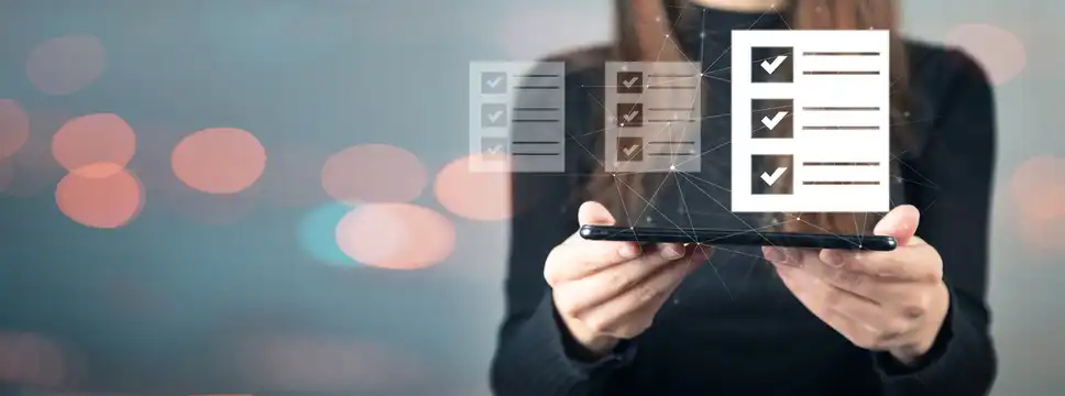 Businesswoman holding a mobile device with illustration of check boxes popping off of the screen to illustrate webinar best practices