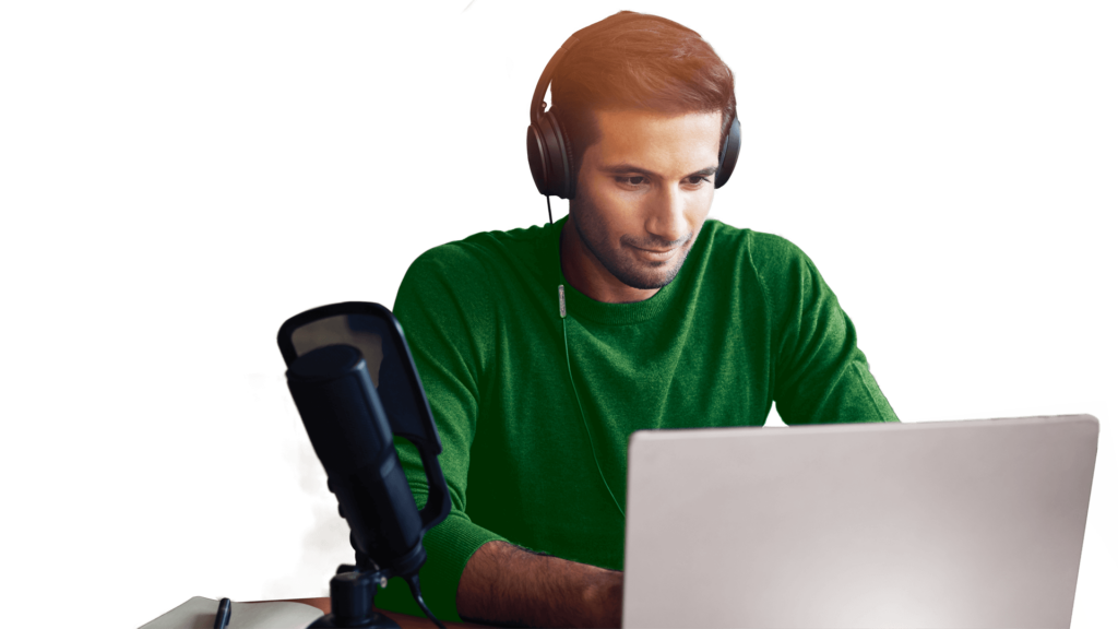 Male wearing headphone typing on a laptop