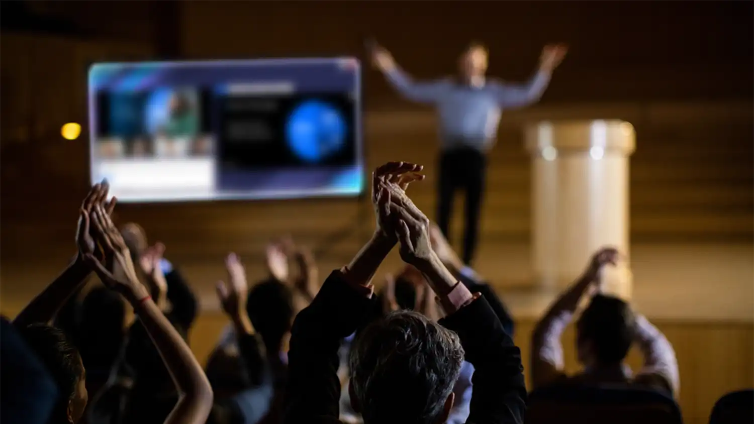 audience applauding a man giving a presentation using globalmeet hybrid event platform