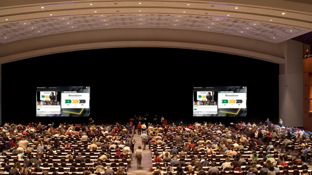 Hybrid Event showing Large Auditorium with audience looking at screens of the online presentation on GlobalMeet's hybrid event platform