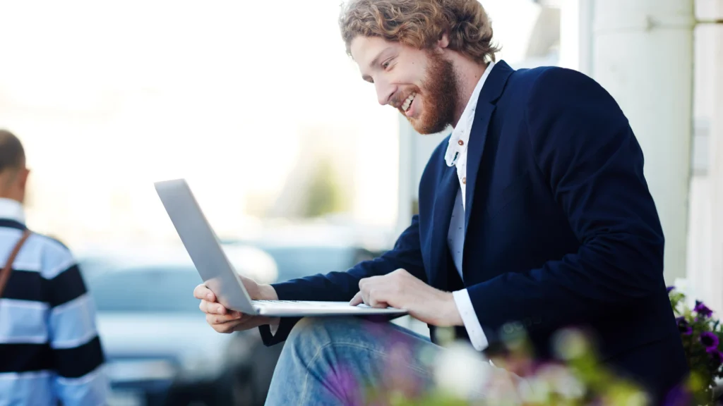 businessman researching event management platforms on his laptop