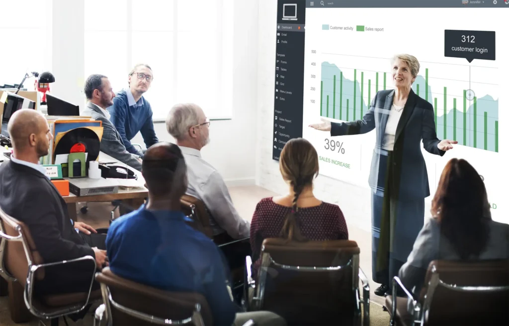 photo of a business woman giving a virtual presentation in front of customers illustrating using virtual event management to improve customer engagement strategy